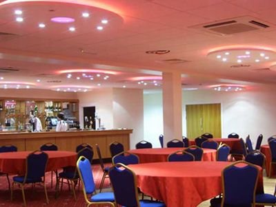 Conference room with bar, illuminated by  concealed lighting – xenon lights, strip lighting 